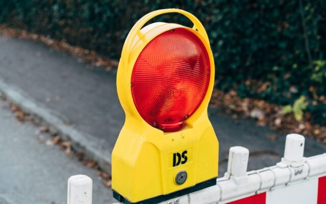 Nahaufnahme einer roten Warnleuchte an einer Baustellenabsperrung