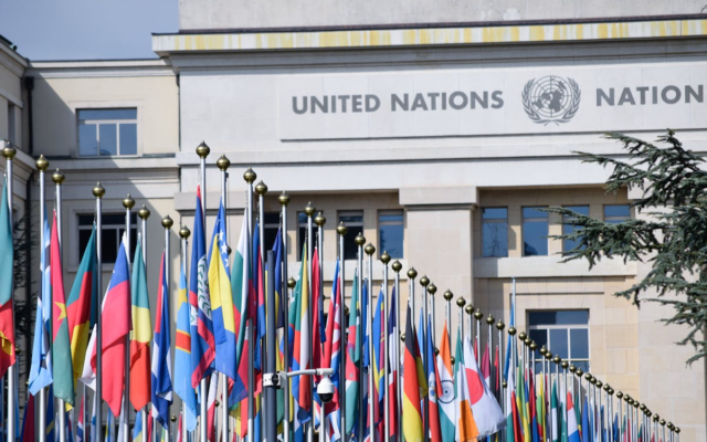 Bunte Flaggen vor dem Büro der Vereinten Nationen in Genf als Symbol für globale Einheit